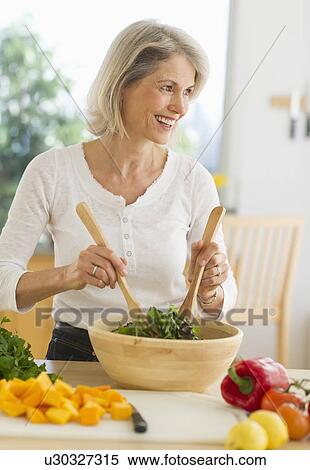JPortrait of senior woman preparing salad in kitchen View Large Photo Image Stock Photography - JPortrait of senior woman preparing salad in kitchen. Fotosearch