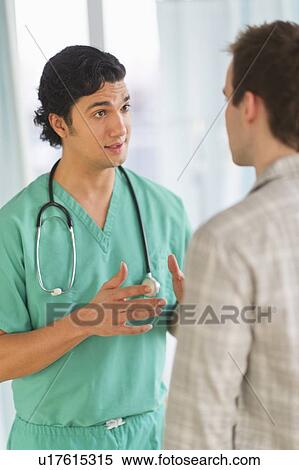 Male doctor talking to male patient in hospital View Large Photo Image Stock Photography - Male doctor talking to male patient in hospital. Fotosearch