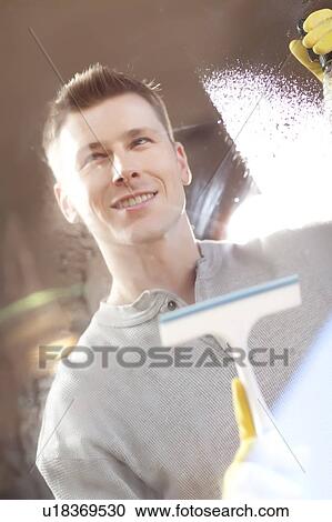 Man cleaning window pane View Large Photo Image Stock Image - Man cleaning window pane. Fotosearch