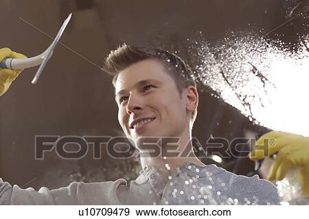 Man cleaning window pane View Large Photo Image Stock Photo - Man cleaning window pane. Fotosearch