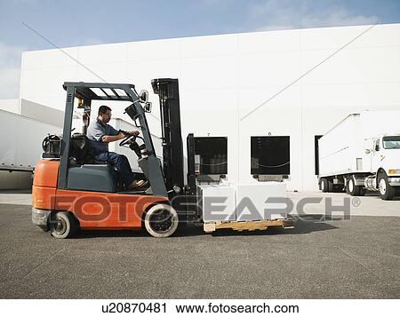 Man driving forklift View Large Photo Image Stock Image - Man driving forklift. Fotosearch
