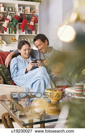 Man giving christmas gift to woman View Large Photo Image Stock Photo - Man giving christmas gift to woman. Fotosearch
