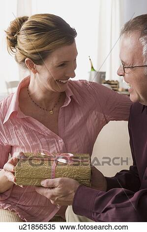 Man giving present to woman View Large Photo Image Stock Photography - Man giving present to woman. Fotosearch