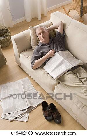 Man having nap on couch View Large Photo Image Stock Photo - Man having nap on couch. Fotosearch