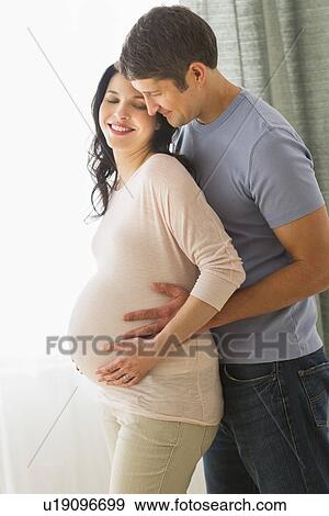 Man hugging pregnant woman View Large Photo Image Stock Photo - Man hugging pregnant woman. Fotosearch
