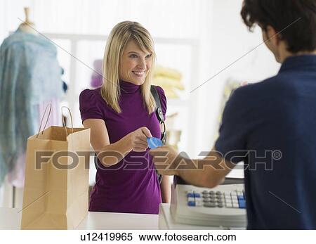Stock Photography - Man paying with credit card. Fotosearch
