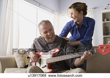 Man playing electric guitar with woman View Large Photo Image Stock Photo - Man playing electric guitar with woman. Fotosearch