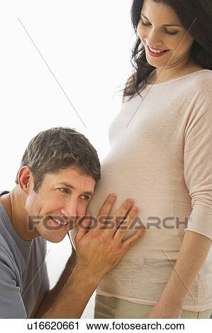 Man putting ear to pregnant woman's belly View Large Photo Image Stock Image - Man putting ear to pregnant woman's belly. Fotosearch