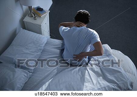 Man sitting on bed View Large Photo Image Stock Image - Man sitting on bed . Fotosearch