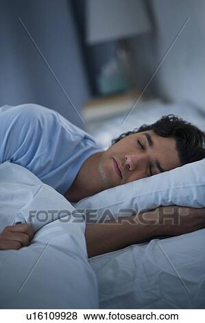 Stock Photo - Man sleeping in bed. Fotosearch
