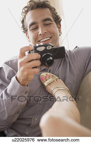 Stock Photograph - Man taking picture of his girlfriend. Fotosearch