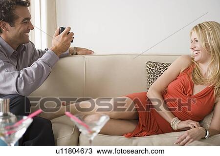 Man taking picture of his smiling girlfriend View Large Photo Image Stock Image - Man taking picture of his smiling girlfriend. Fotosearch
