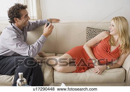 Man taking picture of his smiling girlfriend View Large Photo Image Stock Photo - Man taking picture of his smiling girlfriend. Fotosearch