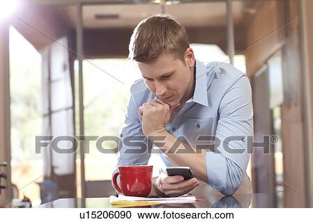 Man texting at home View Large Photo Image Stock Image - Man texting at home. Fotosearch