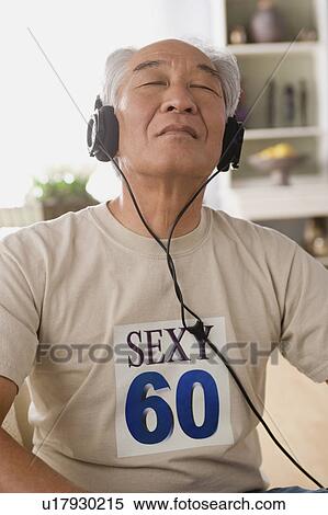 Man with headphones on View Large Photo Image Stock Photography - Man with headphones on. Fotosearch