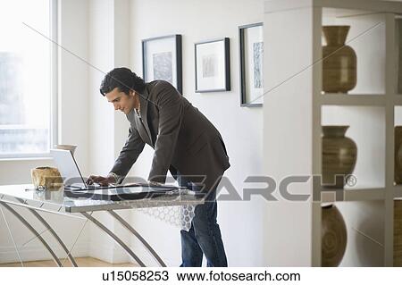 Stock Image - Man working in his art gallery. Fotosearch