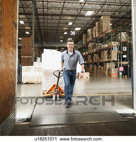 Man working in warehouse View Large Photo Image Stock Image - Man working in warehouse. Fotosearch