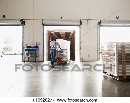 Man working in warehouse View Large Photo Image Stock Photo - Man working in warehouse. Fotosearch