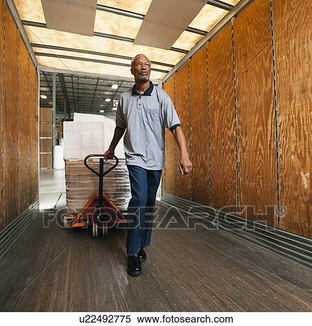 Stock Photography - Man working in warehouse. Fotosearch
