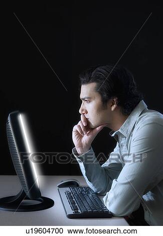 Man working with computer, studio shot View Large Photo Image Stock Image - Man working with computer, studio shot. Fotosearch