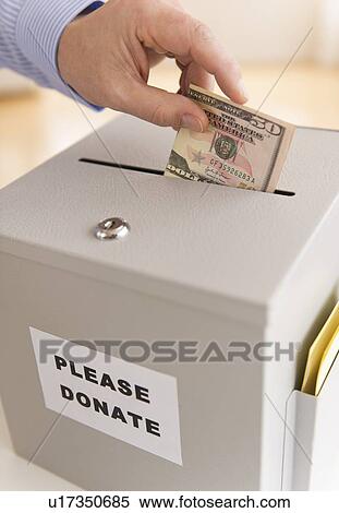 Man's hand putting dollars into donation box View Large Photo Image Stock Photography - Man's hand putting dollars into donation box. Fotosearch