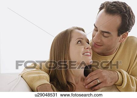 Married couple in close embrace looking at each other View Large Photo Image Stock Image - Married couple in close embrace looking at each other. Fotosearch