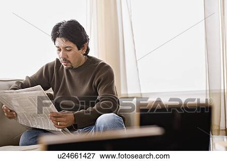 Stock Photo - Mature man reading newspaper. Fotosearch