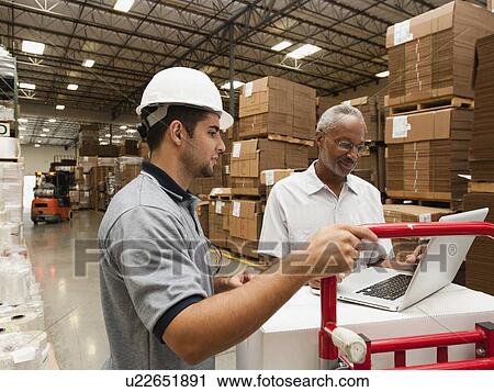 Men working in warehouse View Large Photo Image Stock Image - Men working in warehouse. Fotosearch