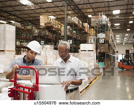 Stock Photograph - Men working in warehouse. Fotosearch
