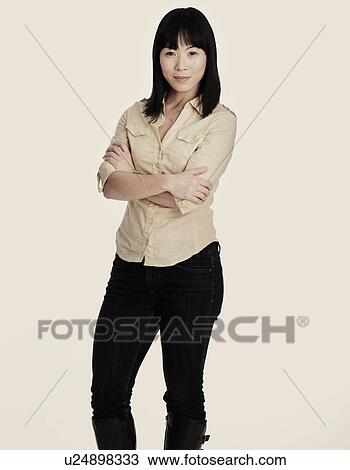 Mid adult smiling woman standing, studio shot View Large Photo Image Stock Image - Mid adult smiling woman standing, studio shot. Fotosearch