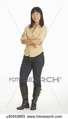 Mid adult smiling woman standing, studio shot View Large Photo Image Stock Image - Mid adult smiling woman standing, studio shot. Fotosearch
