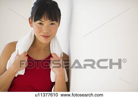 Stock Image - Mid adult woman in gym. Fotosearch