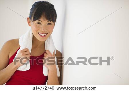 Stock Image - Mid adult woman in gym. Fotosearch
