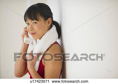 Stock Image - Mid adult woman in gym. Fotosearch