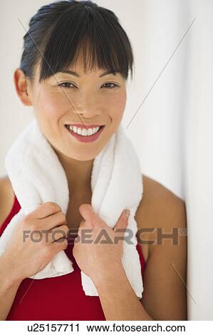 Stock Image - Mid adult woman in gym. Fotosearch