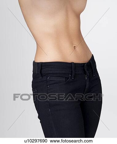 Midsection of slim young woman with flat belly View Large Photo Image Stock Image - Midsection of slim young woman with flat belly. Fotosearch