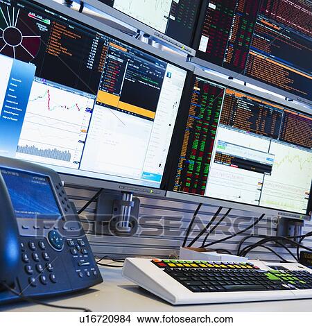 Picture - Monitors above trading desk. Fotosearch