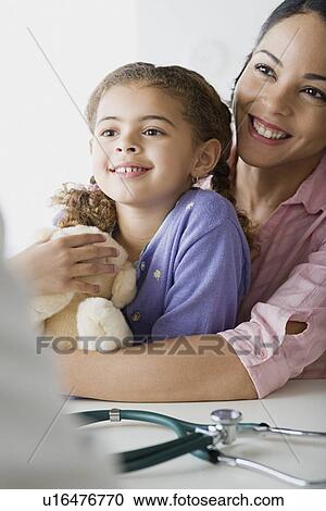 Mother and daughter (10-11) in doctor's office View Large Photo Image Stock Image - Mother and daughter (10-11) in doctor's office. Fotosearch