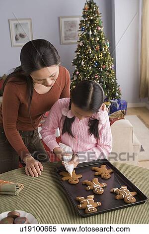 Mother and daughter decorating gingerbread men View Large Photo Image Stock Photography - Mother and daughter decorating gingerbread men. Fotosearch