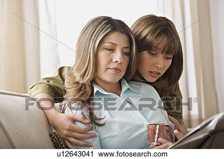 Mother and daughter reading together View Large Photo Image Stock Image - Mother and daughter reading together. Fotosearch