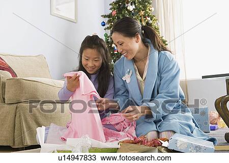 Mother and daughter unwrapping christmas gifts View Large Photo Image Stock Image - Mother and daughter unwrapping christmas gifts. Fotosearch
