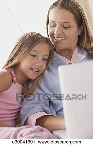 Mother and daughter using laptop View Large Photo Image Stock Image - Mother and daughter using laptop. Fotosearch