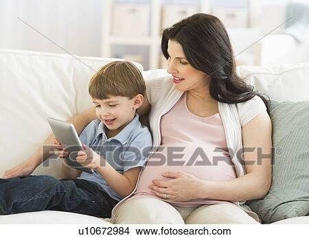 Mother and son (4-5) using tablet pc View Large Photo Image Picture - Mother and son (4-5) using tablet pc. Fotosearch