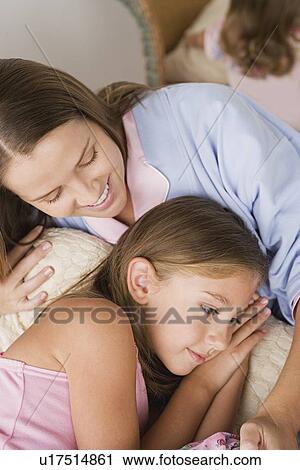 Mother lying in bed with daughter (12-13) View Large Photo Image Stock Image - Mother lying in bed with daughter (12-13) . Fotosearch