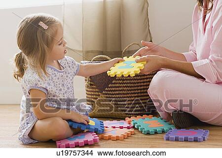 Picture - Mother playing with daughter. Fotosearch