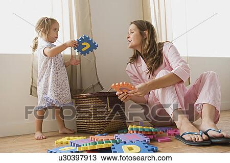 Mother playing with daughter View Large Photo Image Stock Image - Mother playing with daughter. Fotosearch