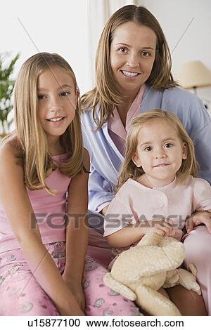 Stock Image - Mother with two daughters (8-9, 12-13). Fotosearch