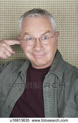 Older man putting finger in ear View Large Photo Image Stock Photography - Older man putting finger in ear. Fotosearch