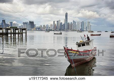 Stock Photography - Panama, Panama City, Fishing boat with skyline in background. Fotosearch