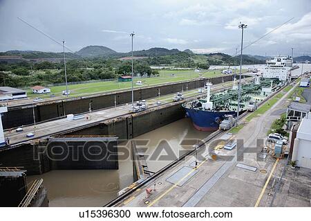 Stock Image - Panama, Panama City, Ship in canal lock. Fotosearch